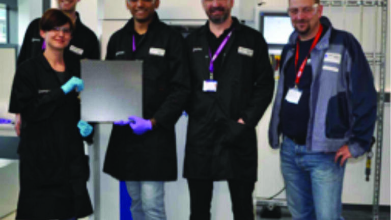 Fully trained GEIC staff proudly display the first composite sample produced on the press. From left to right, Nathan Feddy, Maria Iliut, Arun Prakash and Mark Dickie with P.E.I. trainer Jean Claude Desbriere.


